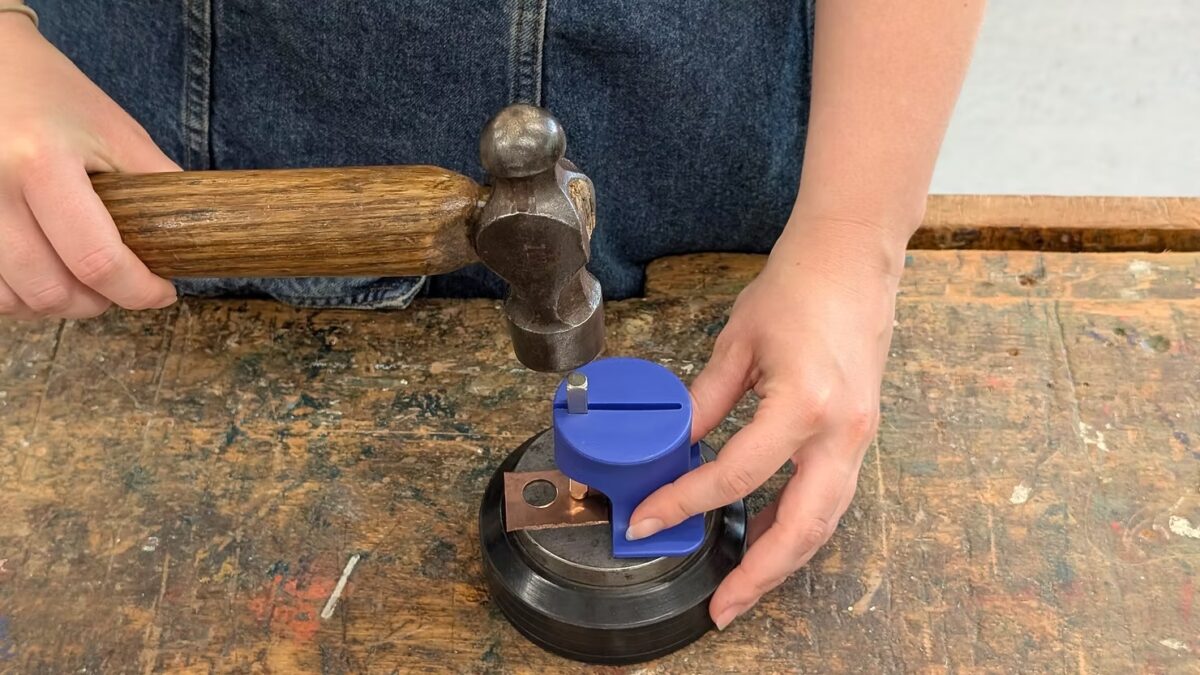 Plastic stamp holder being hammered