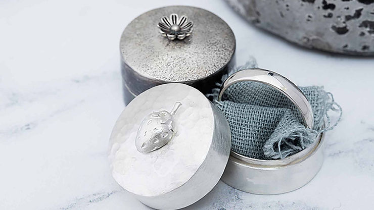 Ring boxes, one with ring inside