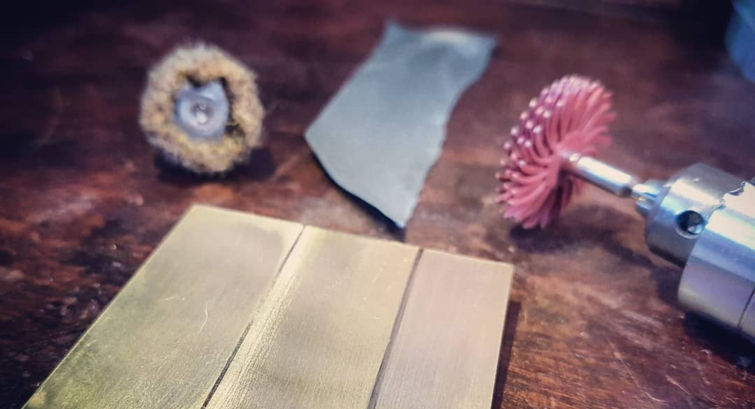 Various tools and materials used for metal finishing and polishing with a rotary tool